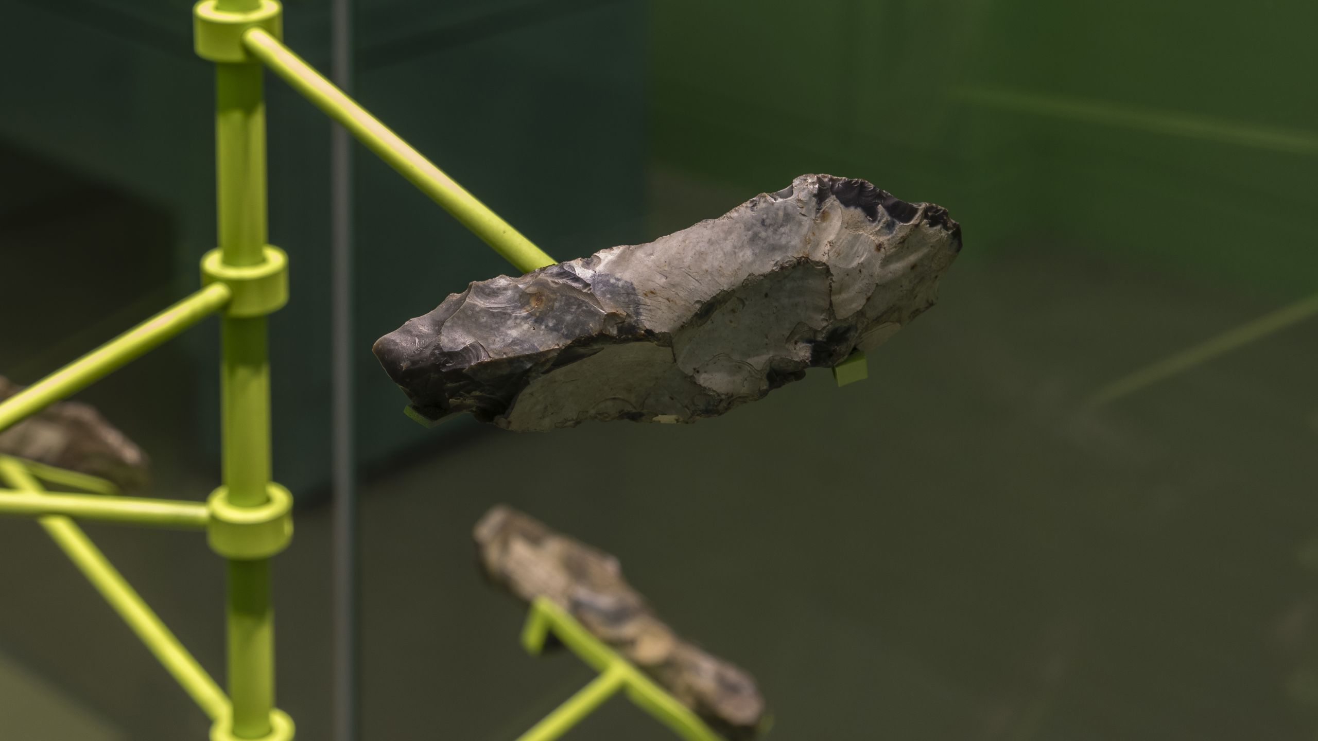 Flint hand axes displayed on green mounts