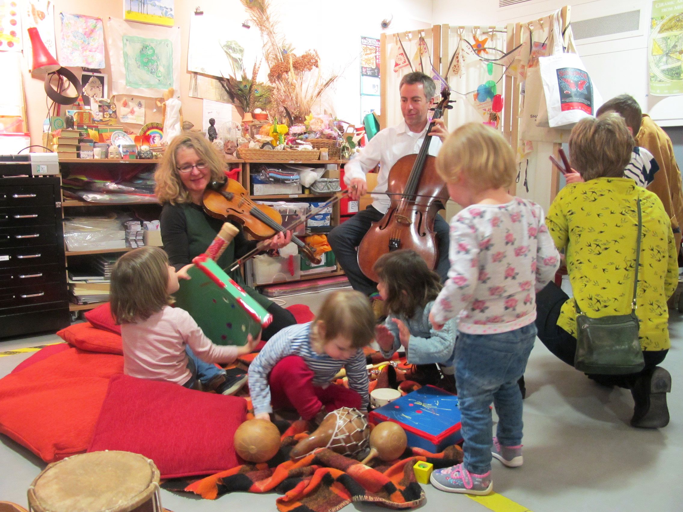 Toddlers enjoy music from a violinist and a cellist