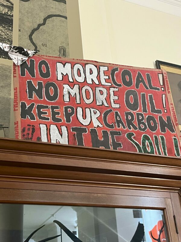 Protest poster displayed on top of a cabinet in the Sedgwick Museum