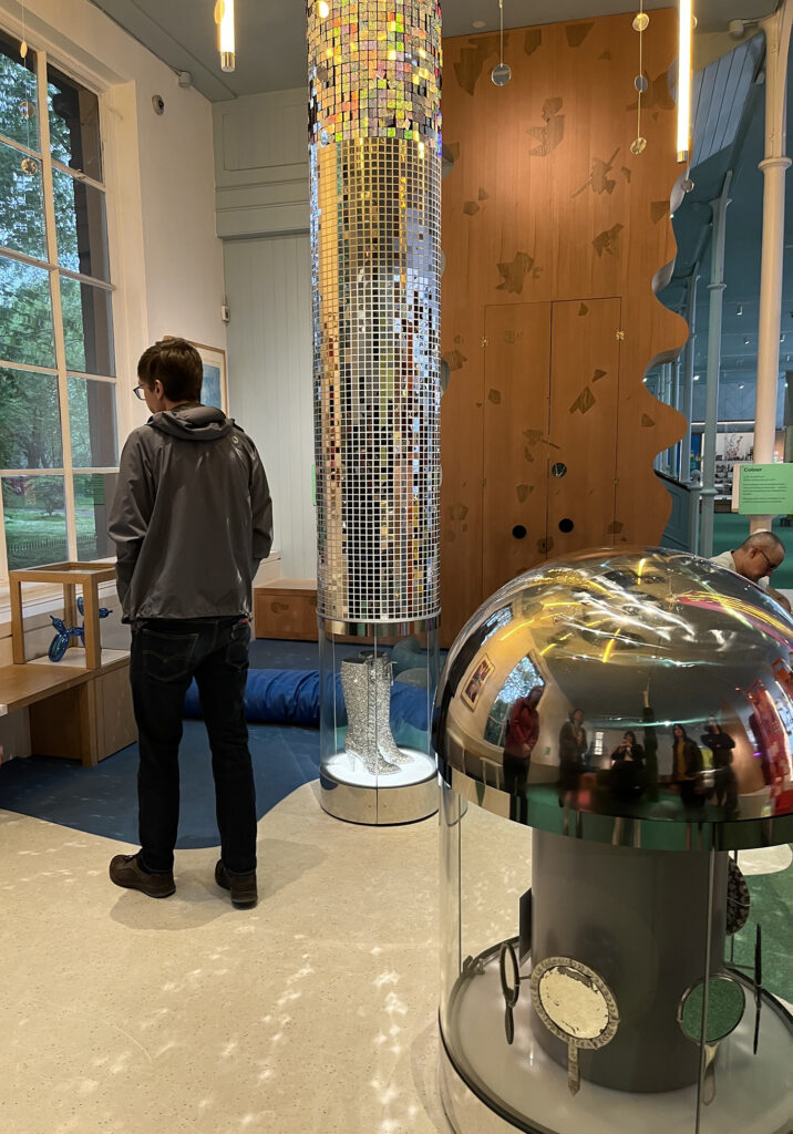 A man stands in the sensory area of the Young V&A, featuring a sparkling column and reflective dome.