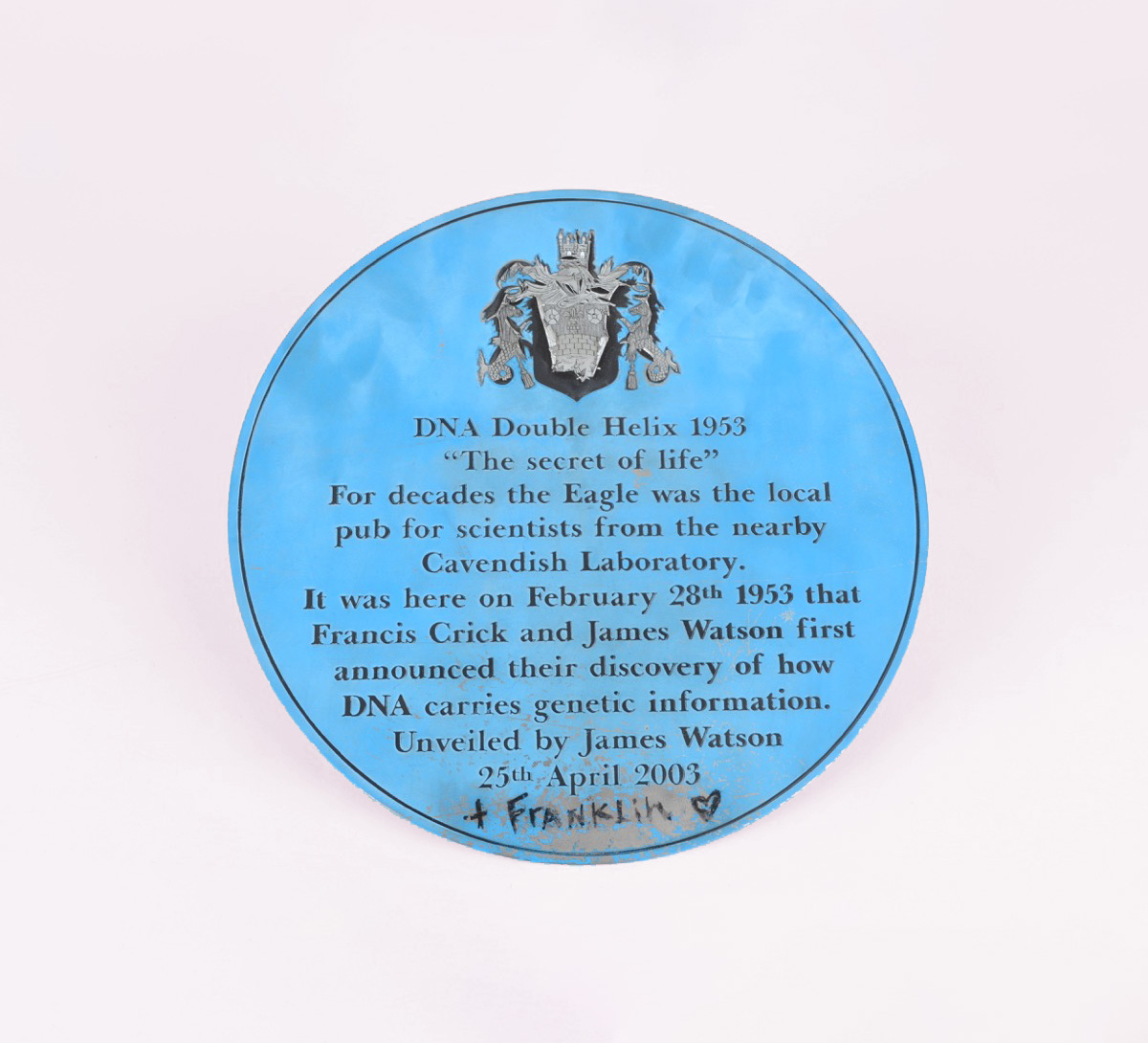 Blue plaque, removed from The Eagle pub, commemorating Watson and Crick's announcement of the discovery of DNA structure, with '+Franklin' in graffito. Object Number: 6807.