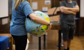 Image of someone holding an inflatable globe 