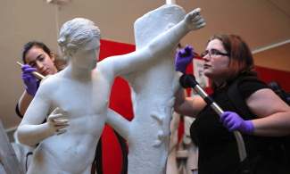 People conserving a cast at the Museum of Classical Archaeology