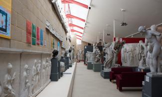 Photograph of one of the walkways of the gallery, casts line each side.