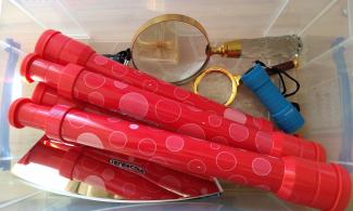 Equipment box containing telescopes, magnifying glasses, torches and mirrors