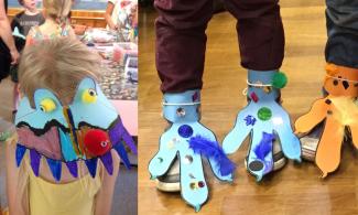 two children child with dinosaur mask and two pairs of childrens feet with card dinosaur feet