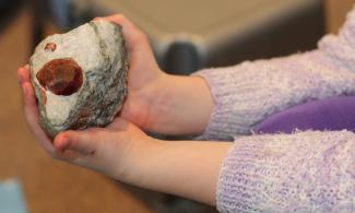 Child holding a rock