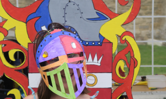 Child wearing a crafted Knight helmet