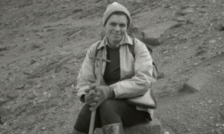black and white photo of woman geologist on a rocky slope