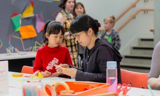 a woman and young girl taking part in creative activities