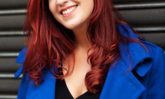 A woman with red hair in a blue coat
