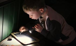 Image of child using a torch in galleries