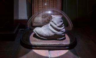Large old-fashioned boot in a display case