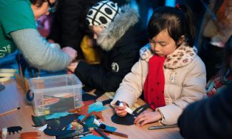 Child doing craft at event