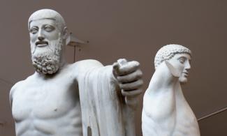 Statue of two male figures, one with a beard, one without