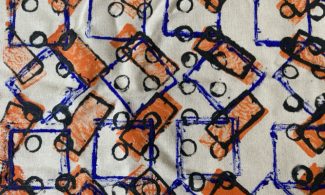 A repeating fabric print of squares, rectangles and circles.