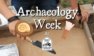 Sand box with spade, with text over the image saying "archaeology week at Denny Abbey Farmland Museum"