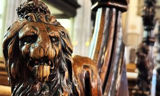 Lion carved out on a wooden pew