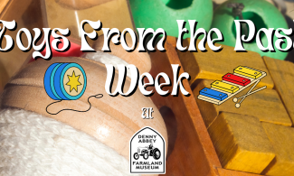 Wooden toys with text saying "Toys from the Past Week at The Farmland Museum"