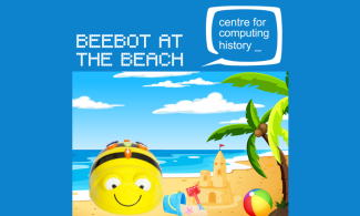 a toy bee edited into a cartoon beach with text that says "Beebot at the Beach"