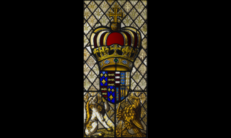 stained glass image of a crown and shield