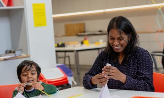 a woman and her child take part in a creative activity 