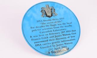 Blue plaque, removed from The Eagle pub, commemorating Watson and Crick's announcement of the discovery of DNA structure, with '+Franklin' in graffito. Object Number: 6807.