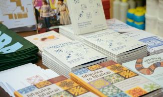 A collection of books on a stand published by Common Threads Press