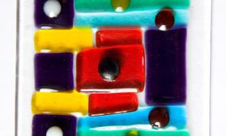 A bright and colourful piece of fused glass.