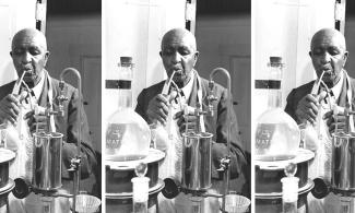 George Washington Carver in his lab - a black and white photograph.