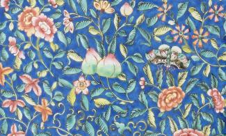 An enamelled vase with blue, red and white decoration. It has two elephant-shaped handles.