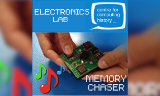 The image shows the picture of a hand holding a game with four pushbuttons and four LEDs.