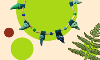 An elasticated string holds beads and coloured plaster cast shark teeth in a range of greens and blues. The coloured teeth are mounted on short straw tubes which the elastic runs through. Together they form a collar shaped necklace. 