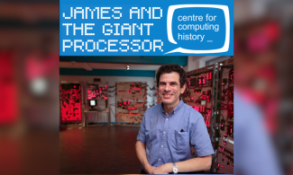 The image shows James Newman in front of the machine he built, the Megaprocessor.