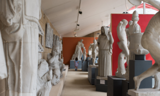 A view down a Cast Gallery, with works of ancient sculpture on either side.