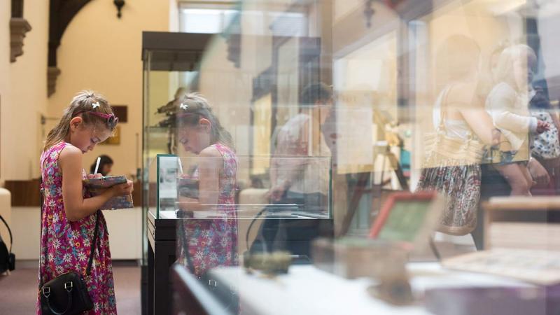 A child exploring the exhibits during summer at the museums