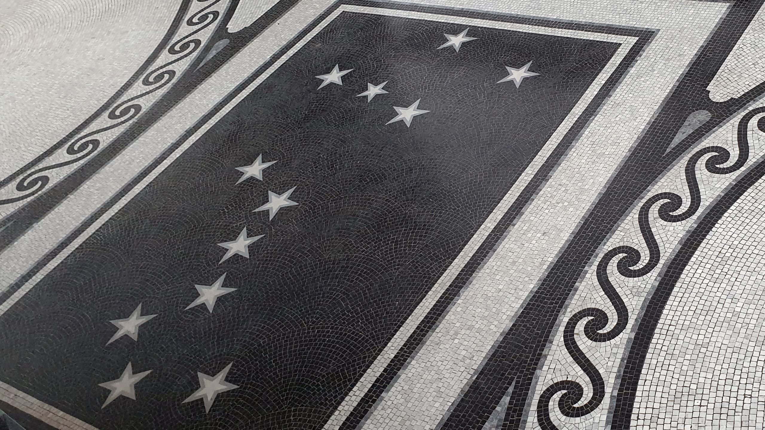 Floor mosaic showing white stars on a black background representing the southern cross and great bear constellations.