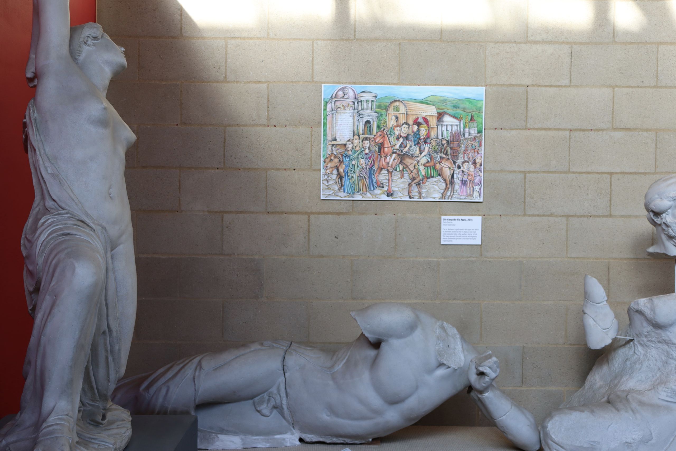 Photograph of the artwork 'Life along the Via Appia' surrounded by plaster casts.