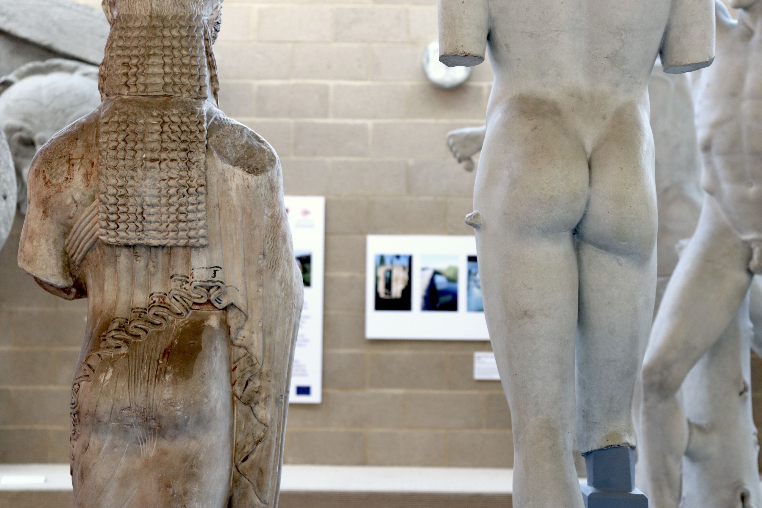 Artwork just visible through the gap between two statues.