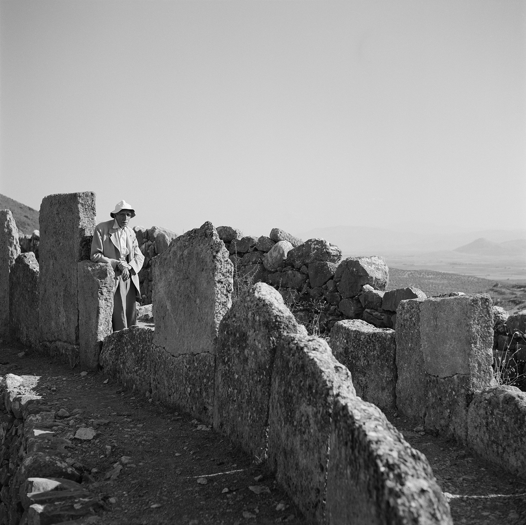 A man stands in a circular stone structure