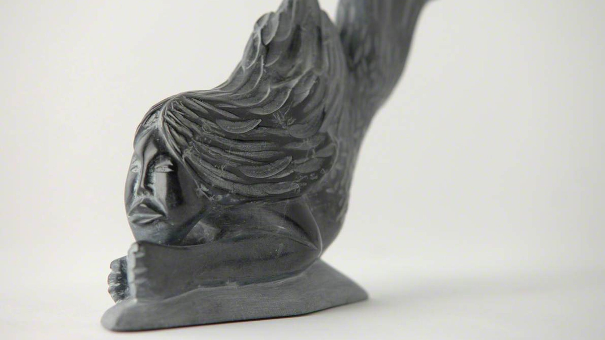 Carving of a woman's face and upper body with a fish lower body.