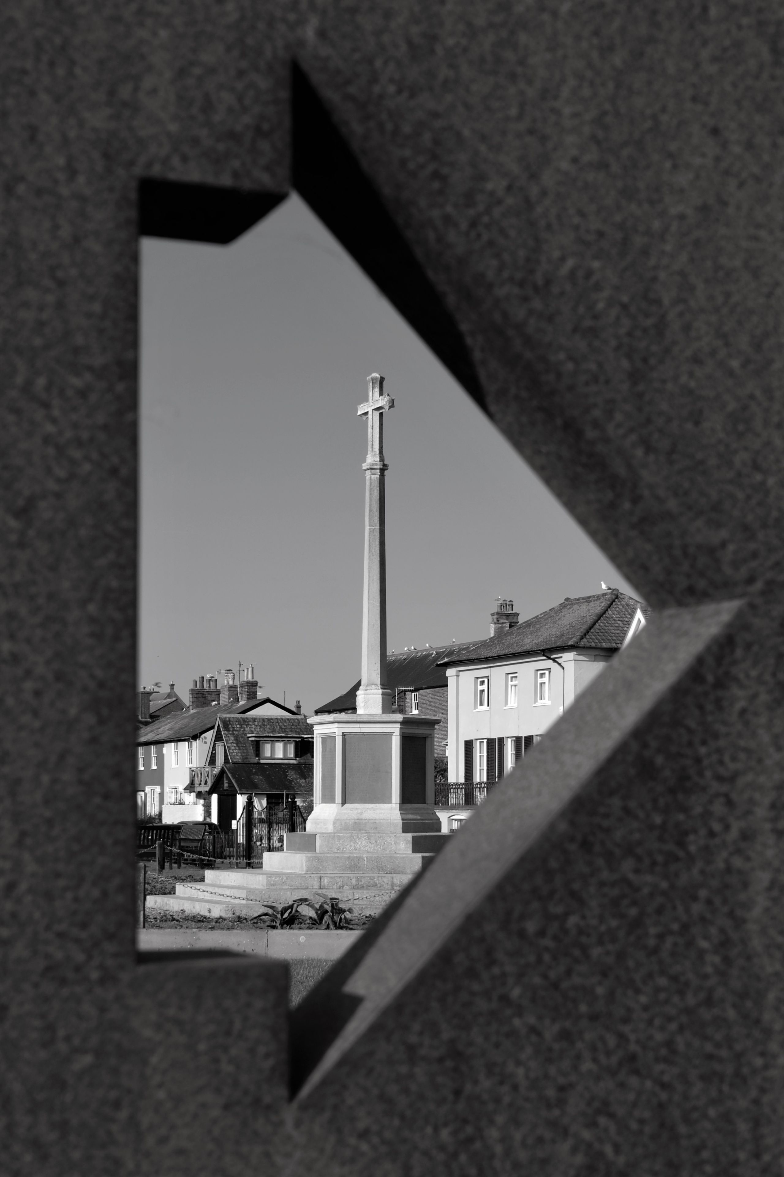 arrow framing a cross, greyscale